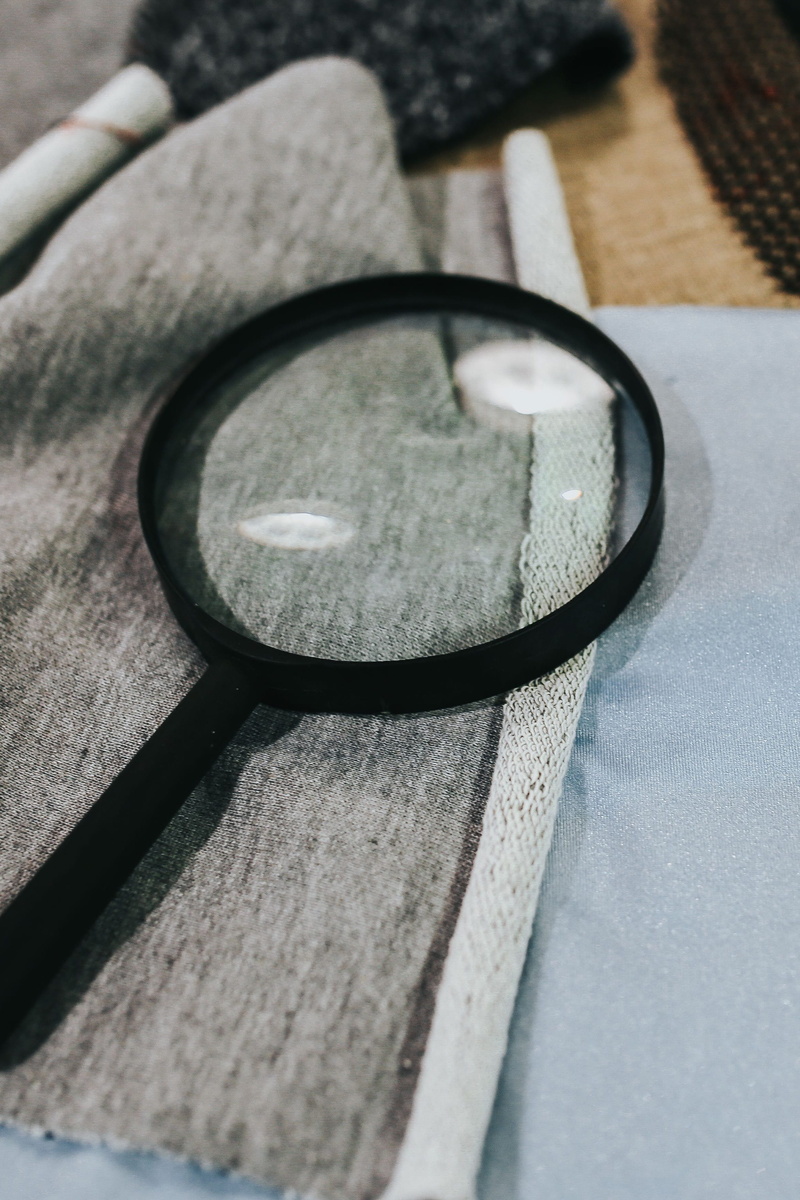 high angle view, glass - material, fabric, magnifying, day, still life, black color, Magnifying glass, table, transparent, personal accessory, cloth, design
