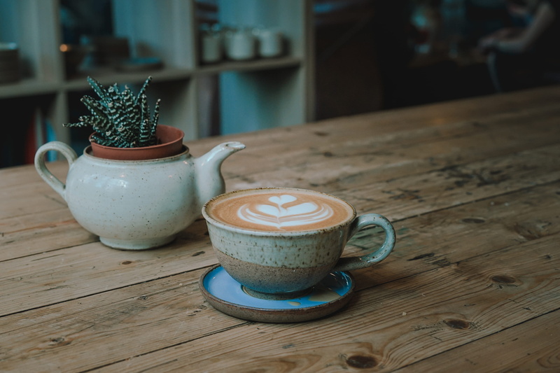food and drink, ceramic, morning, table, modern pottery, indoors, coffee time, beige, wood, close-up, crockery, latte art, frothy drink, freshness, saucer