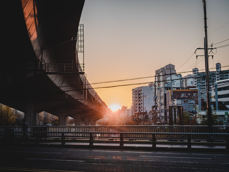 bridge, architecture, sky, street, landscape, road, power supply, cable, built structure, 5K, sunlight, flyover, outdoors, building exterior, orange color