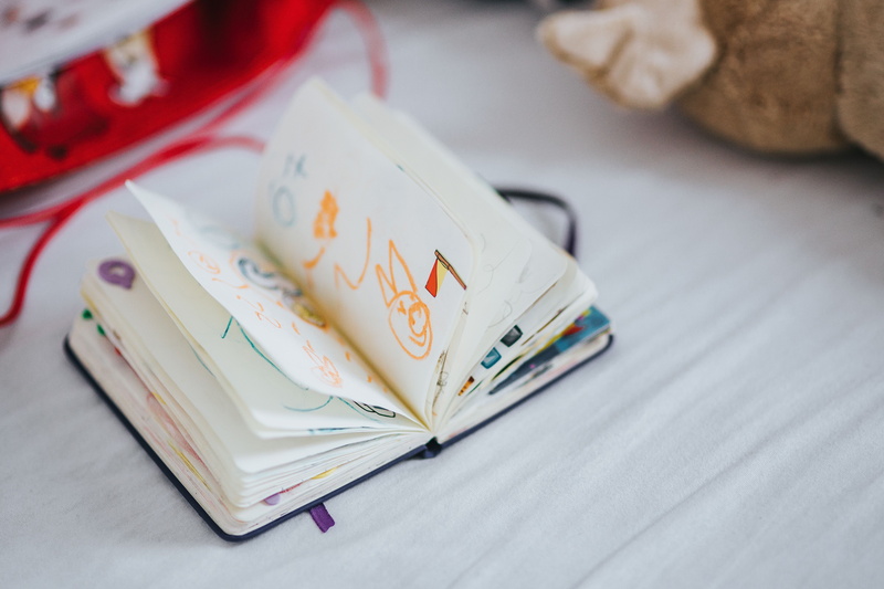 container, stack, playing, focus on foreground, publication, finance, indoors, table, doll, high angle view, book, paper Currency, furniture, business