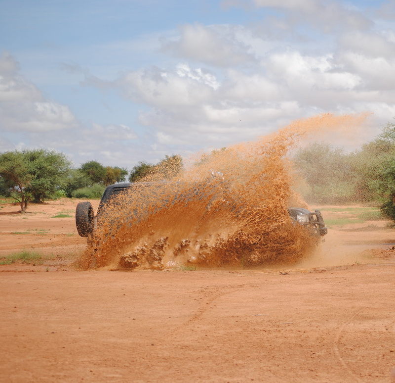 day, sky, agriculture, all terrain, field, plant, tree, dirt, mud, outdoors, no people, 4x4, sunlight, environment, nature, transportation, sun, niger