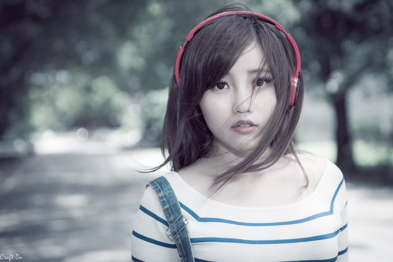 hair in face, looking at camera, outdoors, casual clothing, front view, brunette, hairstyle, Asian, innocence, day, headphones, hair, lifestyles, women