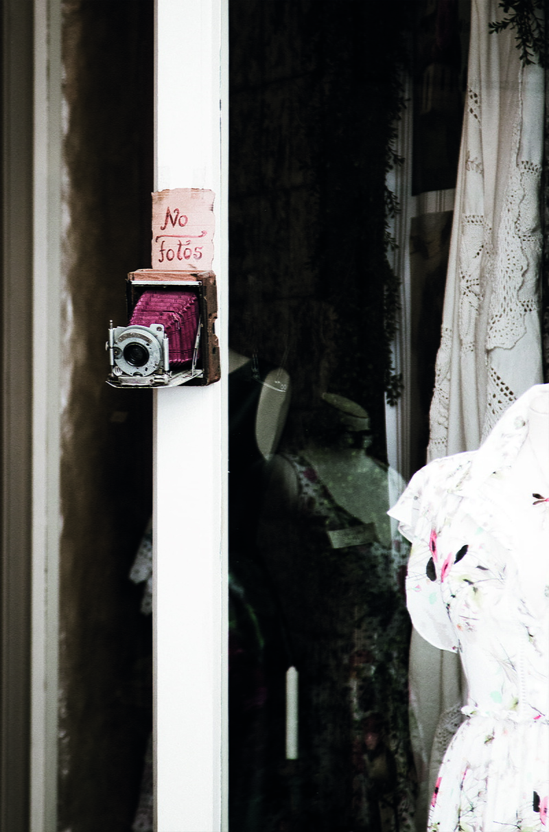 photography, communication, clothing, plaça de sa constitució, reflection, white color, sollér, camera, spain, building, low saturation, red, shop near plaça de sa constitució in sollèr