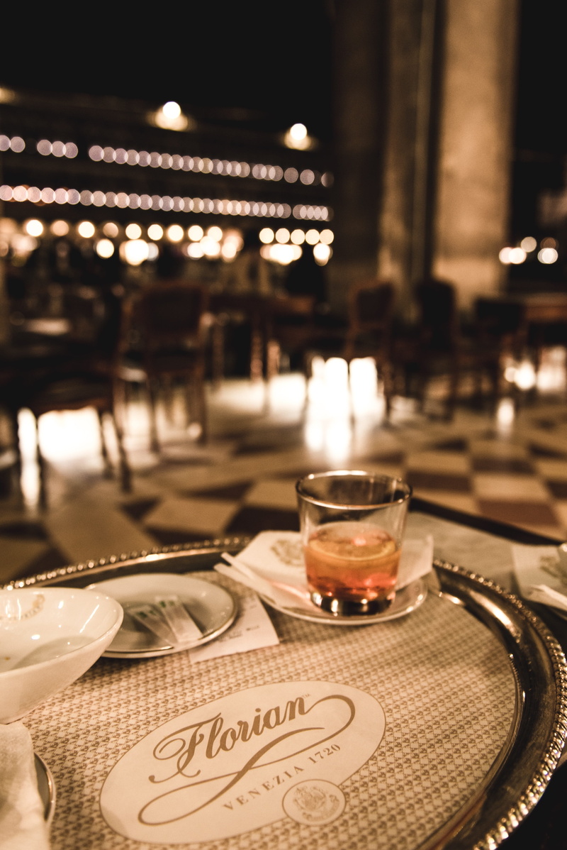 restaurant, night, historic building, Venice, text, focus on foreground, cafe, drink, kitchen utensil, illuminated, household equipment, indoors, romantic