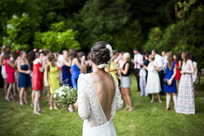dress, positive emotion, couple - relationship, outdoors, woman, back, adult, group, toss, life events, bouquet, wedding, people, jubilant, event, group of people