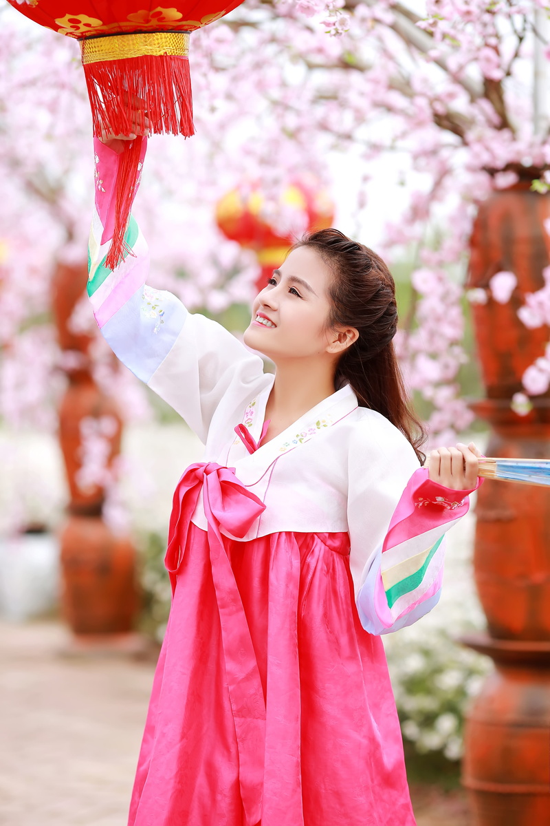 young, focus on foreground, real people, front view, culture, cute, fun, costume, fashion, outdoors, one person, belief, smiling, holding, young adult