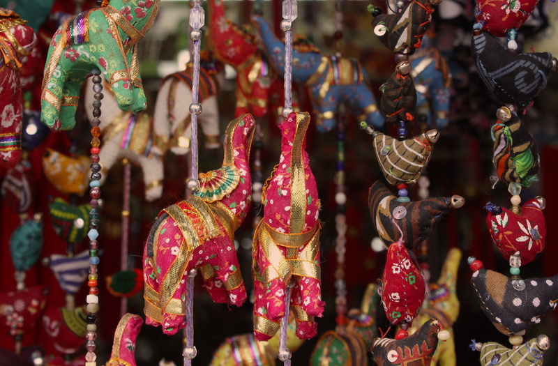 retail display, barrio chino, elephant, elephants, street, large group of objects, city, focus on foreground, cityline, hanging, texture, china town, pattern