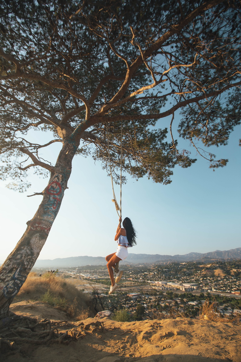 branch, california, land, long hair, tree, beauty in nature, outdoors, tranquility, swinging, up the hill, swingset, woman, hairstyle, cityline, summer time