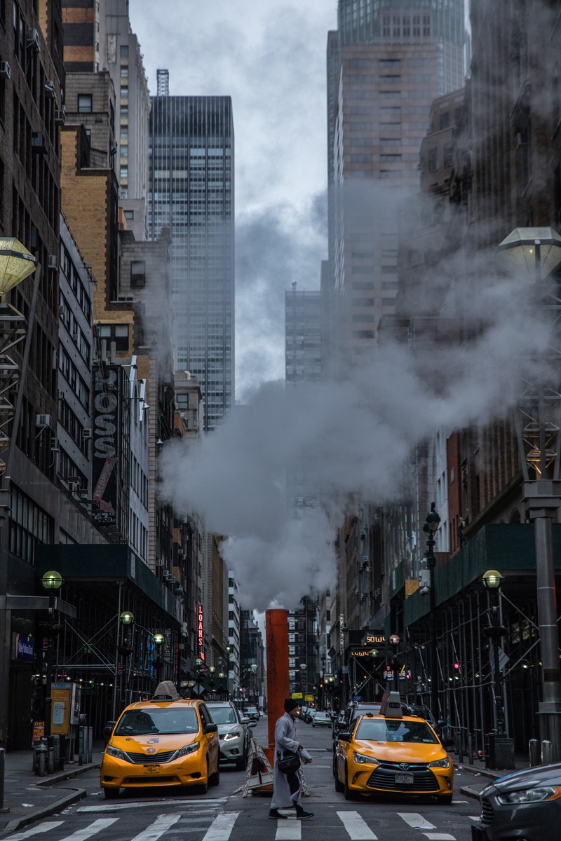 pedestrian, taxis, person, land vehicle, vehicles, cityline, day, buildings, air pollution, city street, mode of transportation, building exterior, taxi