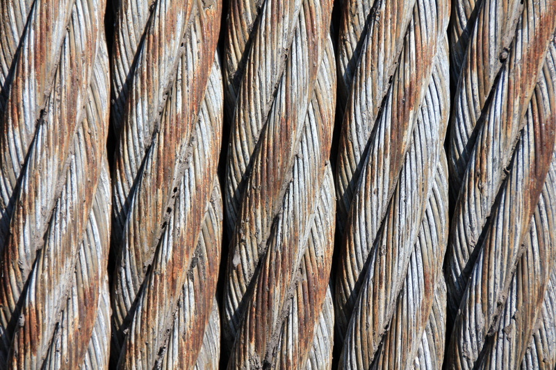 no people, brown, braided, large group of objects, row, directly above, weathered, wood - material, business, rope, outdoors, oxidation, metal, wire, day