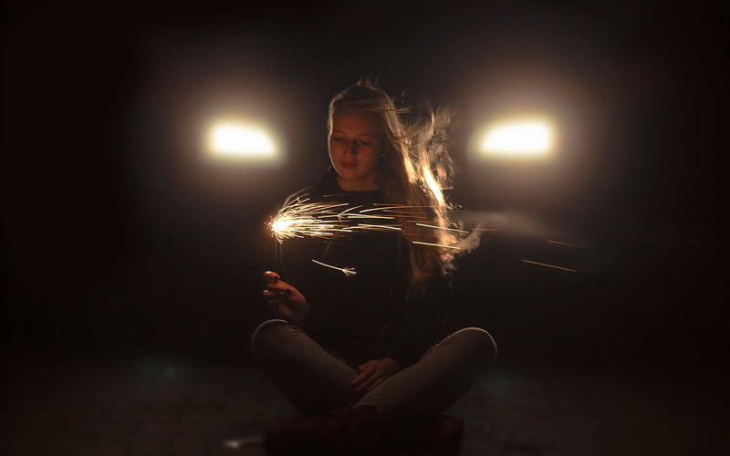 vehicle, car, studio shot, young adult, casual clothing, indoors, illuminated, adult, model, real people, front view, sparkler, long hair, motion, holding