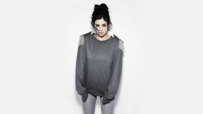 simple background, one person, open mouth, copy space, sweater, young women, young adult, studio shot, women, casual clothing, hair in face, singer, looking at camera