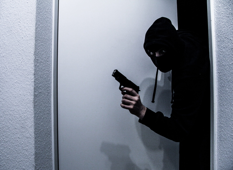 window, weapon, adult, telephone, gangster, indoors, smart phone, communication, holding, security, pistol, social issues, connection, young adult, thief