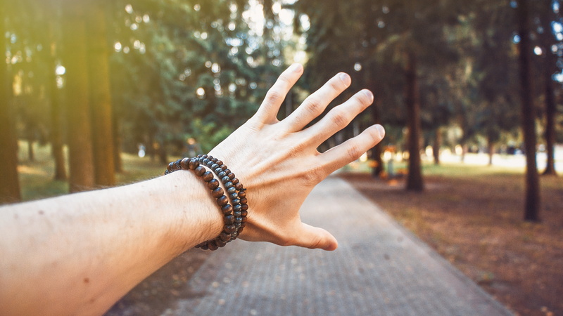 outdoors, bracelets, forest, close-up, human hand, plant, lifestyles, finger, one person, nail, tree, day, bracelet, focus on foreground, nature, adult