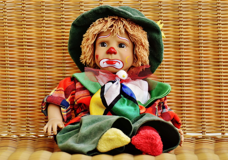 looking at camera, clown, human representation, creativity, childhood, toy, day, cute, multi colored, sad, home interior, male likeness, portrait, sweet