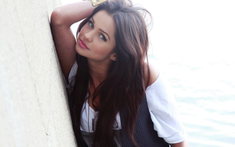 young adult, blue eyes, arms up, waist up, standing, looking at camera, beauty, one person, adult, beautiful woman, hair, contemplation, hairstyle, brunette