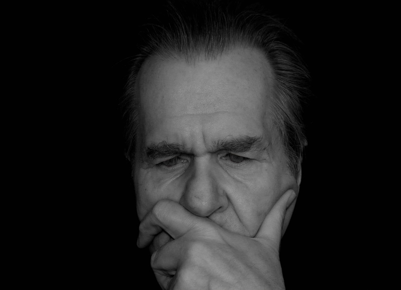 human face, emotion, indoors, portrait, adult, man, headshot, hand, frustration, think, body part, black-and-white, person, negative emotion, contemplation