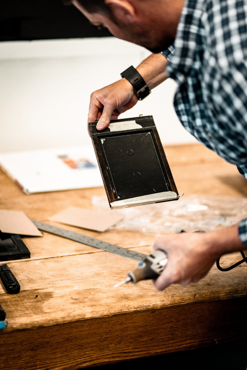 wireless technology, power, human body part, creativity, carpenter, table, person, floor, human hand, laptop, workshop, wrist, one person, men, wood, indoors