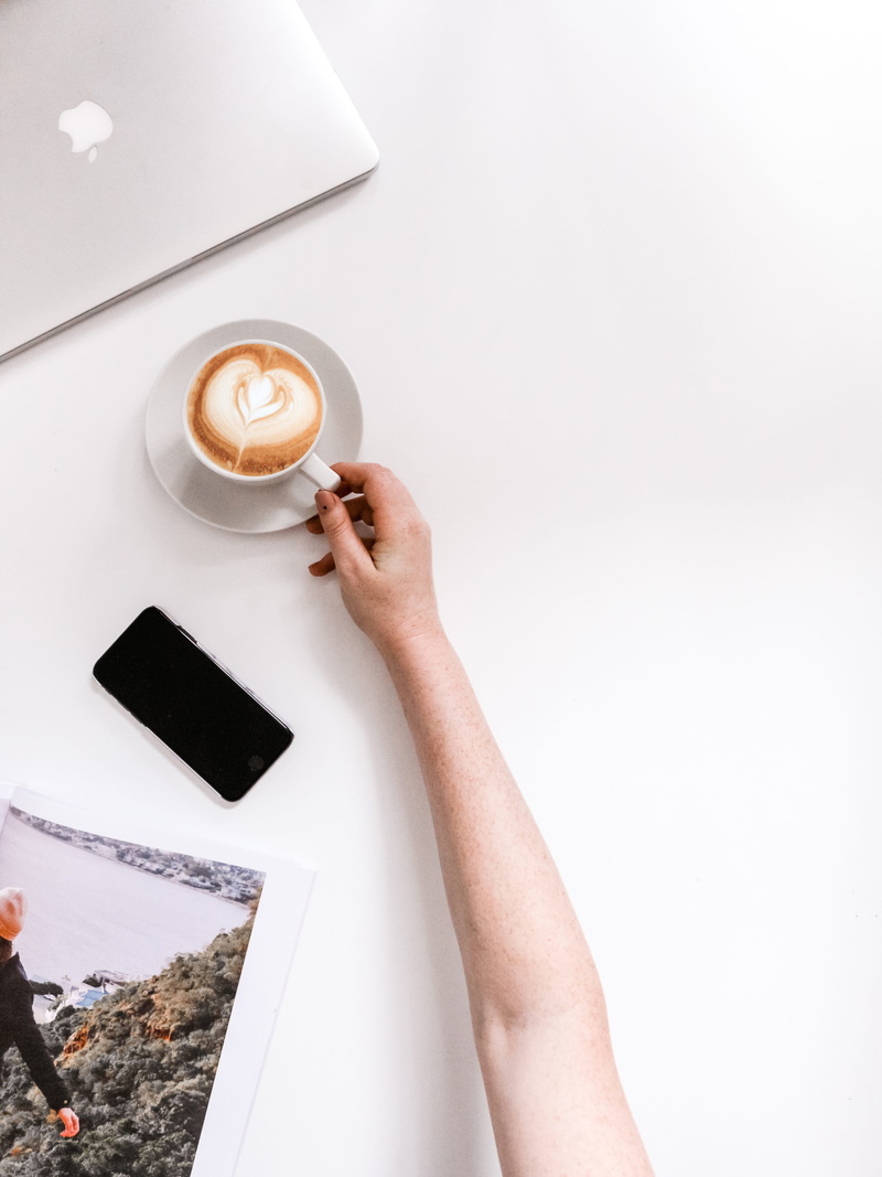 one person, poster, shelf, high angle view, arm, human, electronics, finger, human body part, person, holding, latte, coffee - drink, black, lifestyles