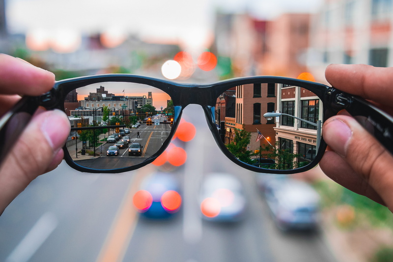 human hand, adult, reflection, finger, architecture, focus on foreground, city life, human body part, communication, focus, streets, day, street, portable information device