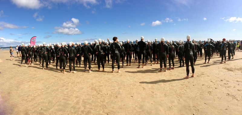 real people, swimmer, healthy, competitive, land, athletic, start, triathletes, exercise, ocean, wetsuit, cloud - sky, sunlight, group, panoramic, black