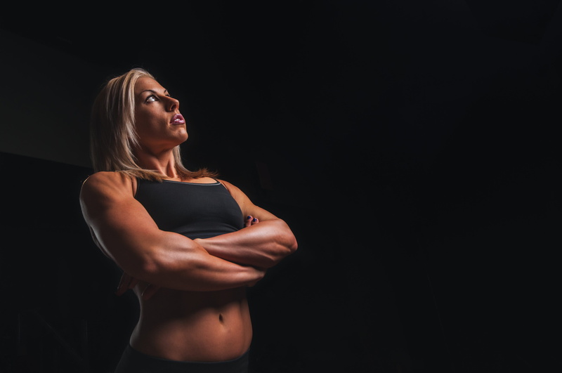 one person, muscular build, young adult, exercising, fit, human body part, dark, copy space, studio, indoors, arms, strength, body, abdominal muscle, woman