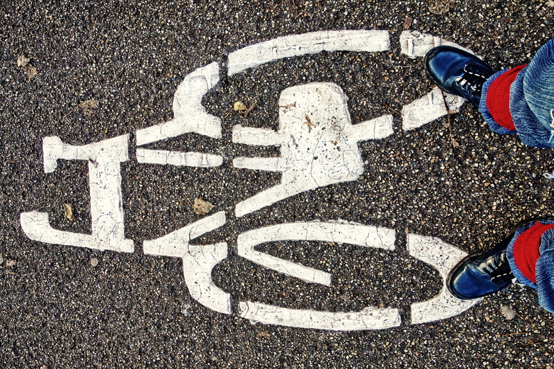 human leg, shoes, outdoors, asphalt, transportation, feet, day, jeans, communication, high angle view, icon, white color, symbol, body part, human foot