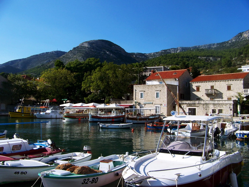 port, lake, day, yacht, transportation, built structure, sky, harbor, mountain, mode of transportation, travel, clear sky, architecture, nature, no people