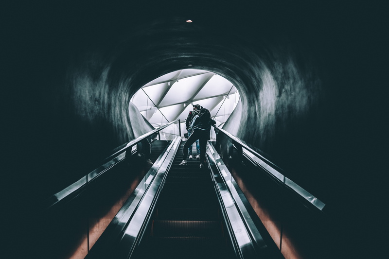 architecture, indoors, built structure, lifestyles, convenience, two, transportation, railing, standing, city, one person, dark, steps and staircases, men