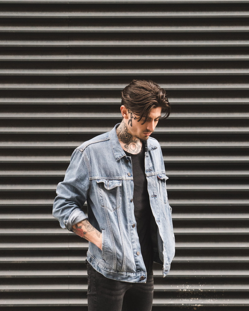 hipster - person, door, demin jacket, outdoors, front, texture, leisure activity, standing, manchester, looking out, daytime, fashion, looking down, real people