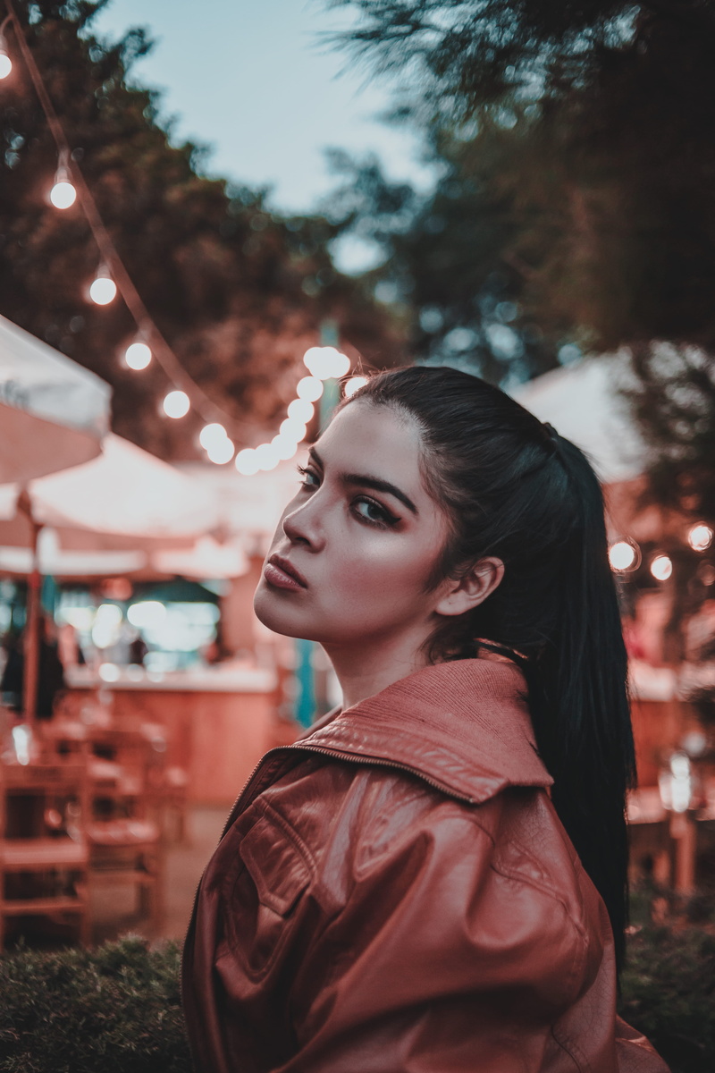 leisure activity, color, hairstyle, left, women, jacket, young adult, clothing, standing, beauty, orange, looking, looking at camera, street, night, young women