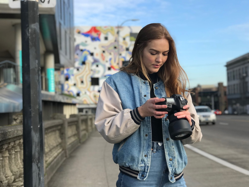 road, jean jacket, outdoors, beautiful woman, person, denim jacket, real people, photographer, wear, jacket, architecture, urban, three quarter length