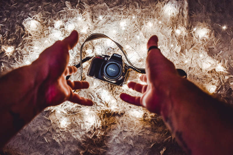 human limb, holding, nikon, leisure activity, real people, 4K, finger, string lights, human, people, human body part, hand, close-up, high angle view