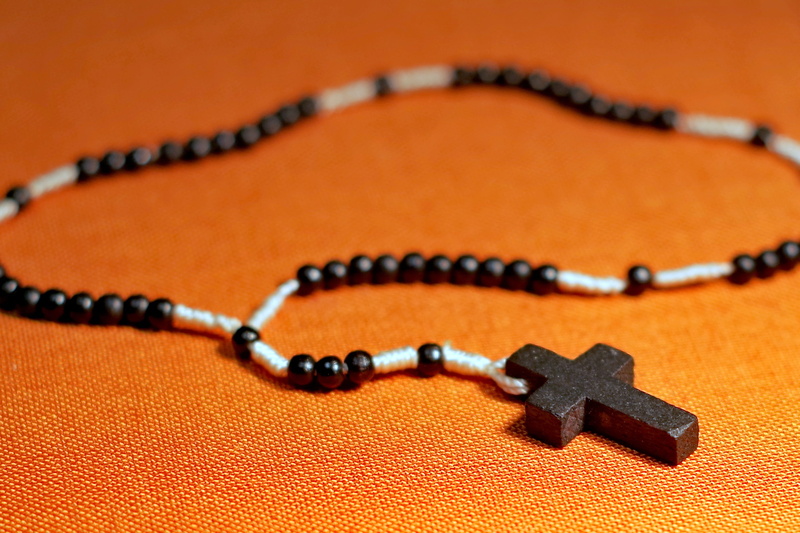 prayer, craft, jesus, rosary, colored background, orange color, single object, studio shot, focus on foreground, cross, faith, religious, indoors, 2K