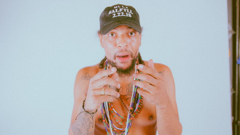 front view, accessories, shirt, holding, accessory, hat, portrait, rosary, white, bead, person, s, back, teenager, apparel, shirtless, skin, ornament, headshot