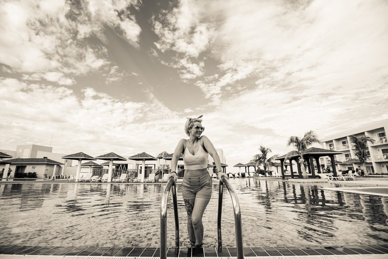 cloud - sky, 8K, picsine, front view, vintage, pinup, south, pool, leisure activity, cuba, water, one person, nature, sky, casual clothing, hotel, lifestyles