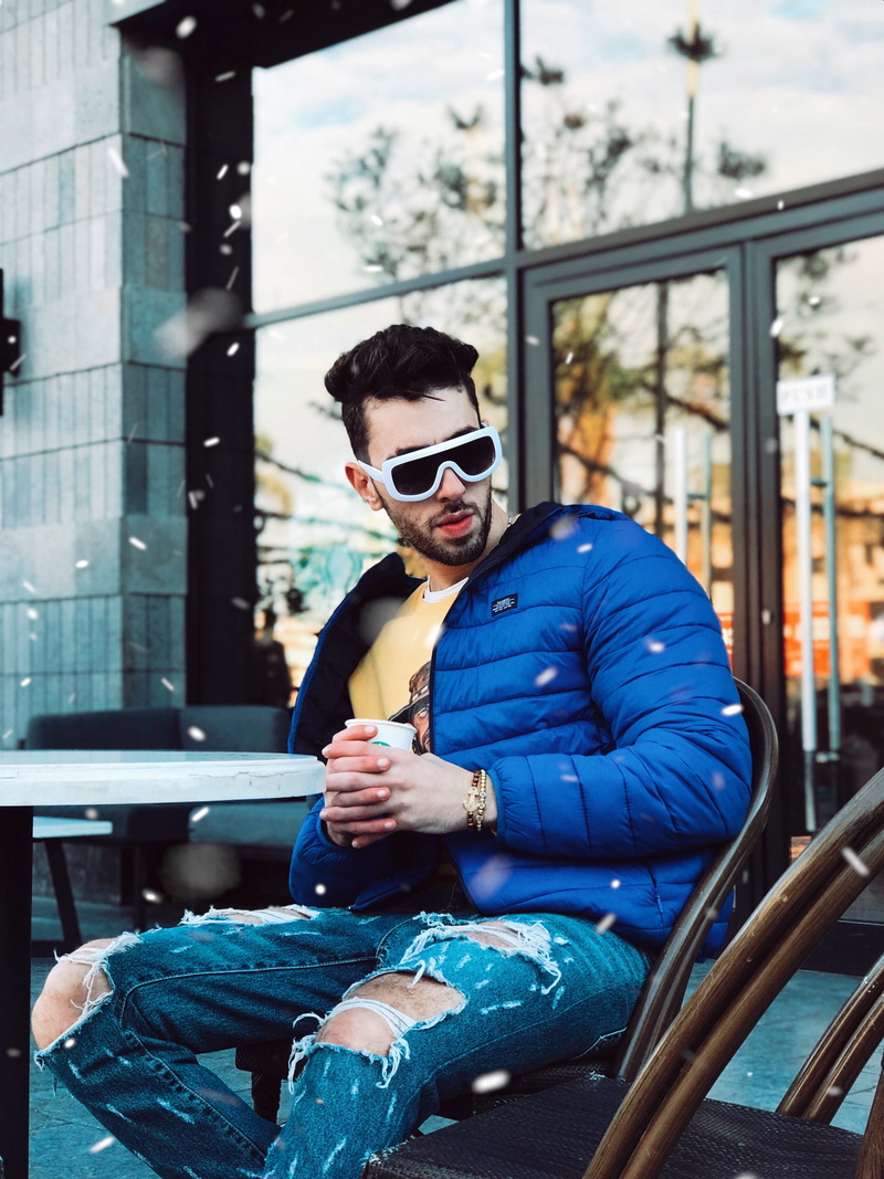 glasses, outdoors, urban, architecture, street, leisure activity, photoshoot, one person, sit, wear, front view, cup, drink, good-looking, looking, indoors