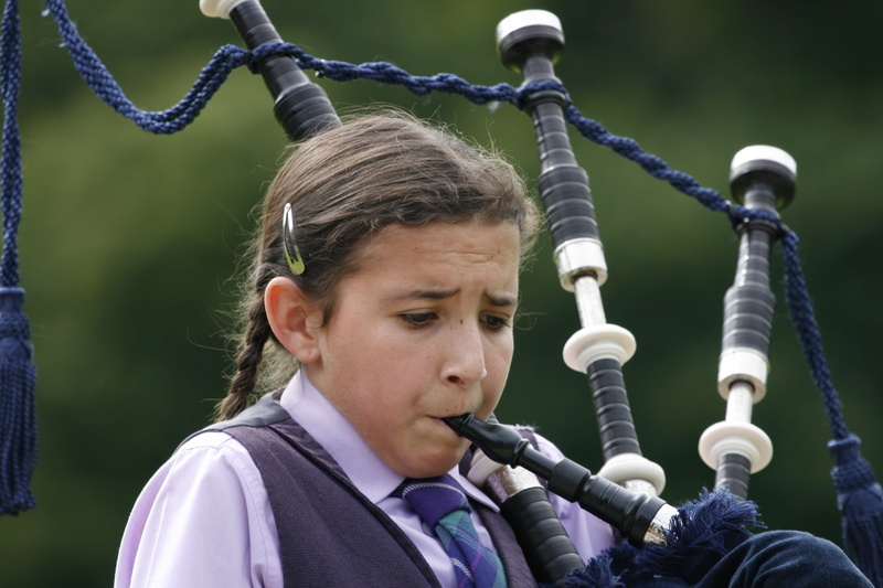 clothing, human face, wind, playing, day, one man only, looking, close-up, nature, wind instrument, highlandgames, hair, exhausting, woman, casual clothing