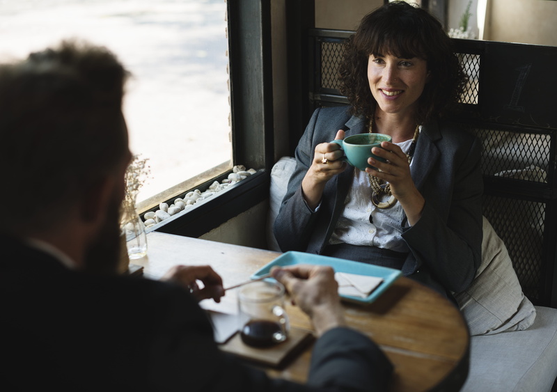food and drink, break, sitting, real people, wear, 5K, working, casual clothing, hands, employee, smiling, leisure, adult, smile, technology, room, sit