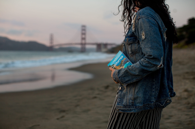 denim, leisure activity, standing, holding, 5K, overcoat, clothing, lifestyles, casual clothing, golden gate bridge, human, hair, coat, paper, brochure