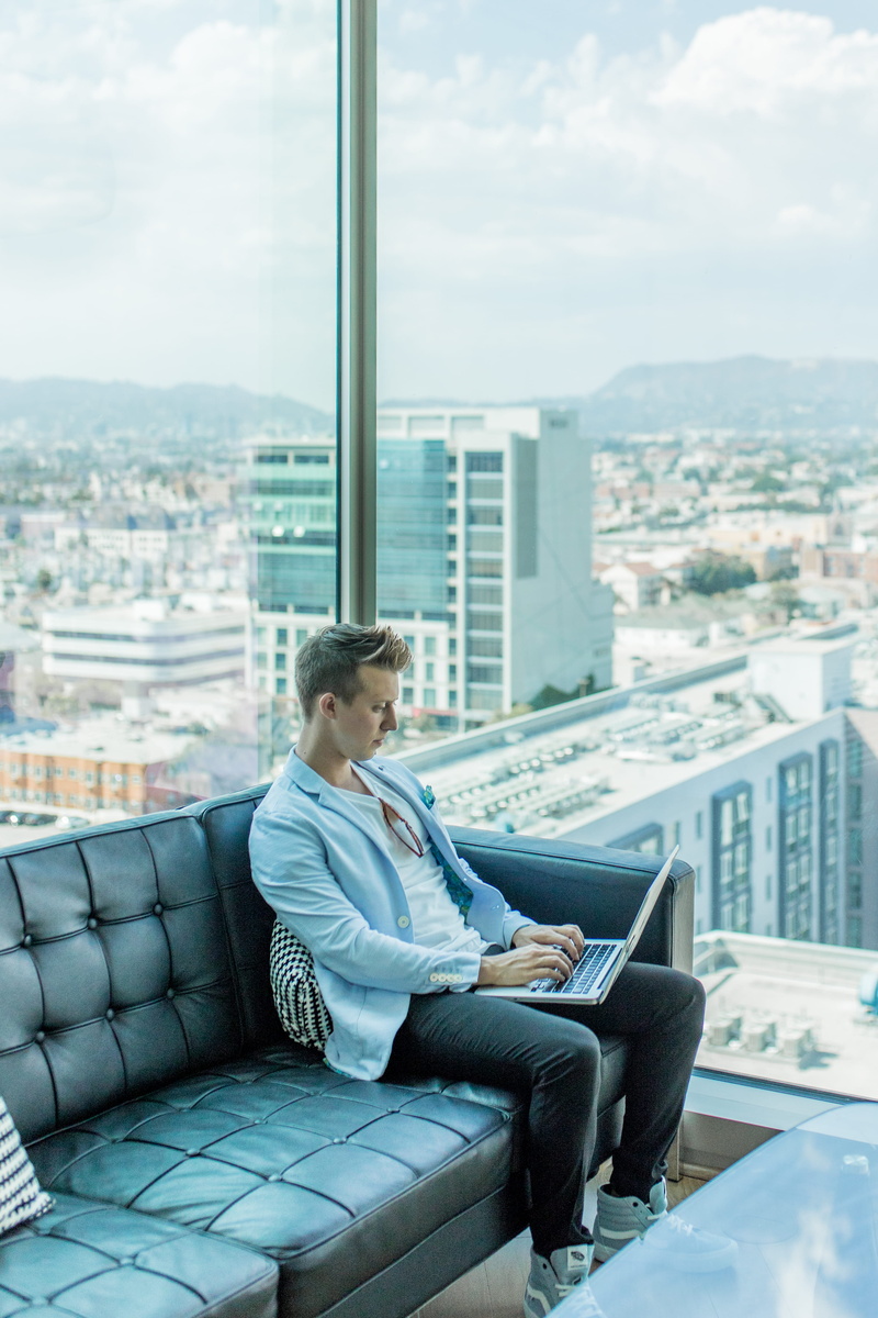 technology, built structure, outdoors, city, computer, one person, casual clothing, real people, 4K, using laptop, s, full length, cityscape, sitting