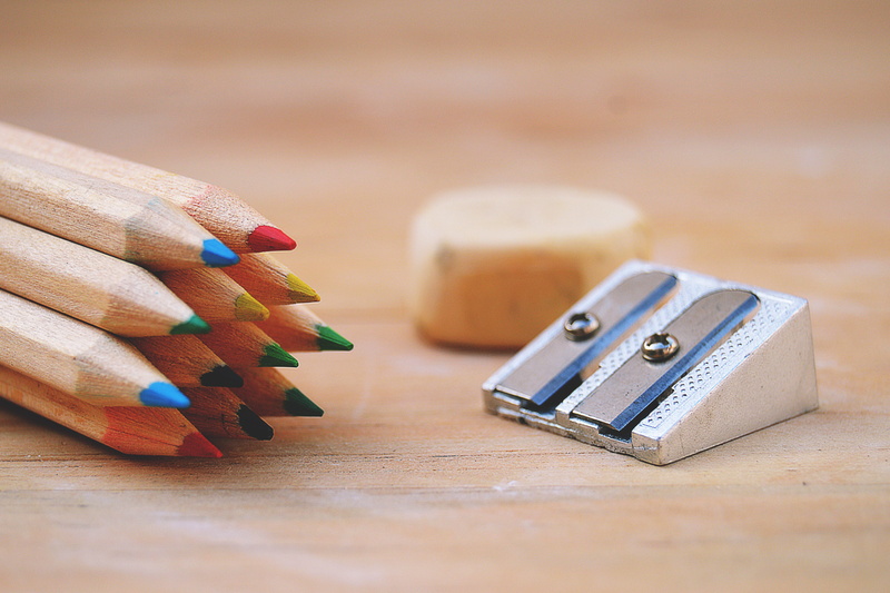 art and craft equipment, pencils, focus on foreground, small group of objects, writing instrument, wood - material, various, table, school, pencil sharpener