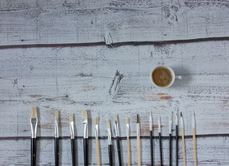 coffee cup, indoors, day, brush, coffee, the art of, high angle view, coffee - drink, artist, mug, white coffee, table, refreshment, backgrounds, drink
