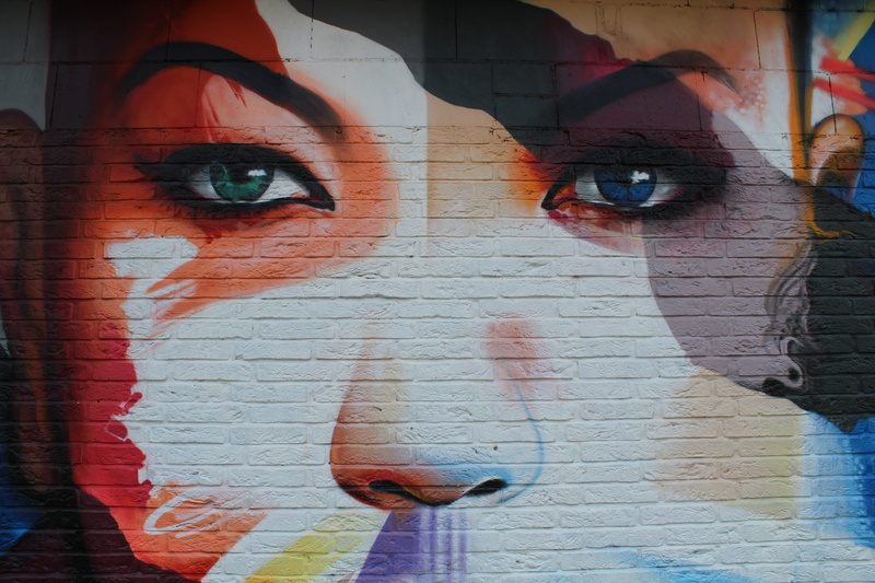 street art, wall, leisure activity, face, looking at camera, built structure, close-up, painted wall, girl, real people, mid adult, Sprayer, representation