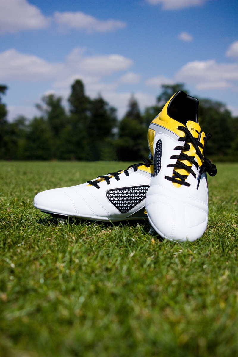 football, pair, sports equipment, shoe, leisure activity, Sport, ball, golf, no people, Field, boots, cloud - sky, soccer, liverpool, cleats, white color
