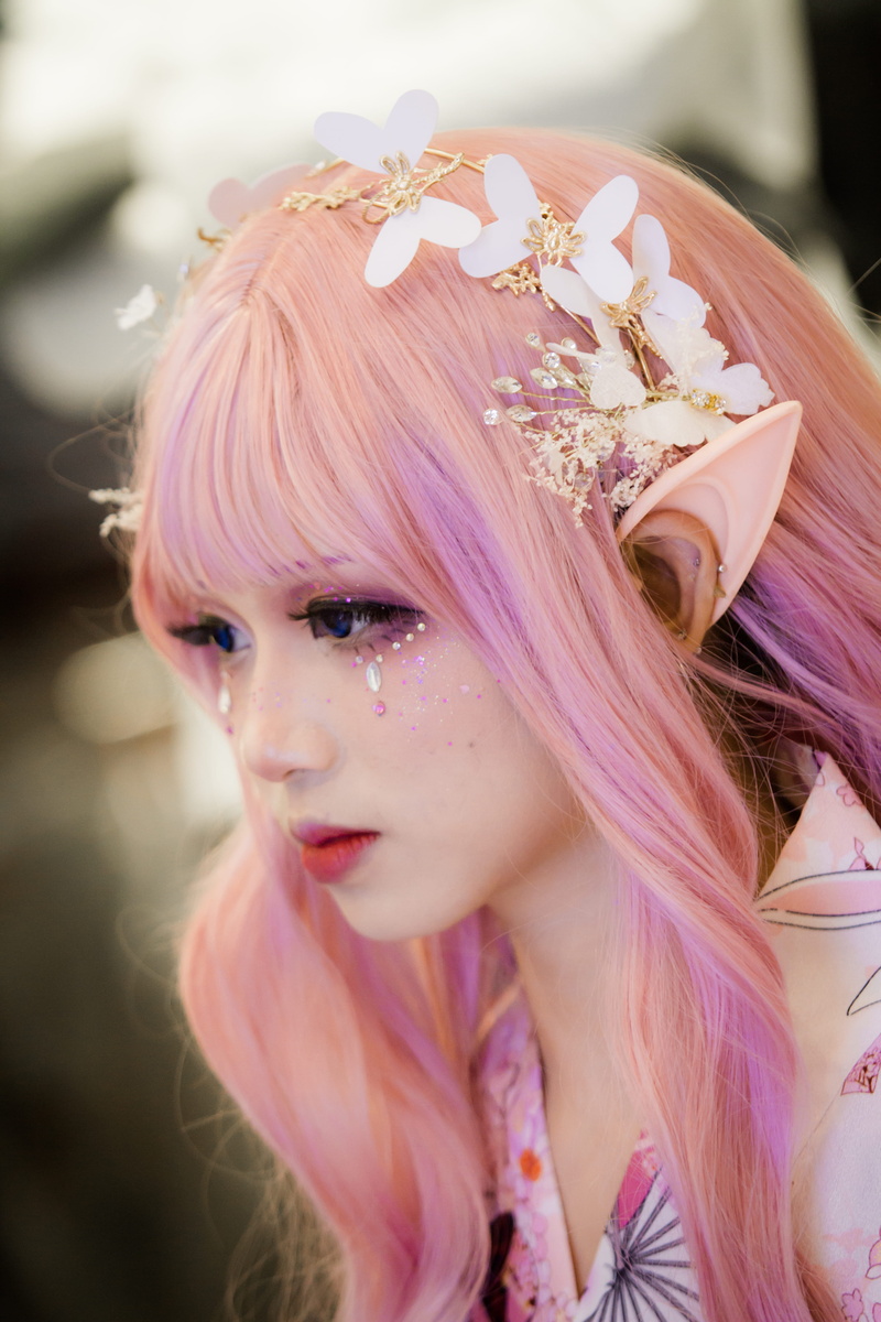 headdress, outdoors, close-up, side view, person, focus on foreground, flower crown, cosplay, 5K, lifestyles, beautiful, real people, women, ear, pretty