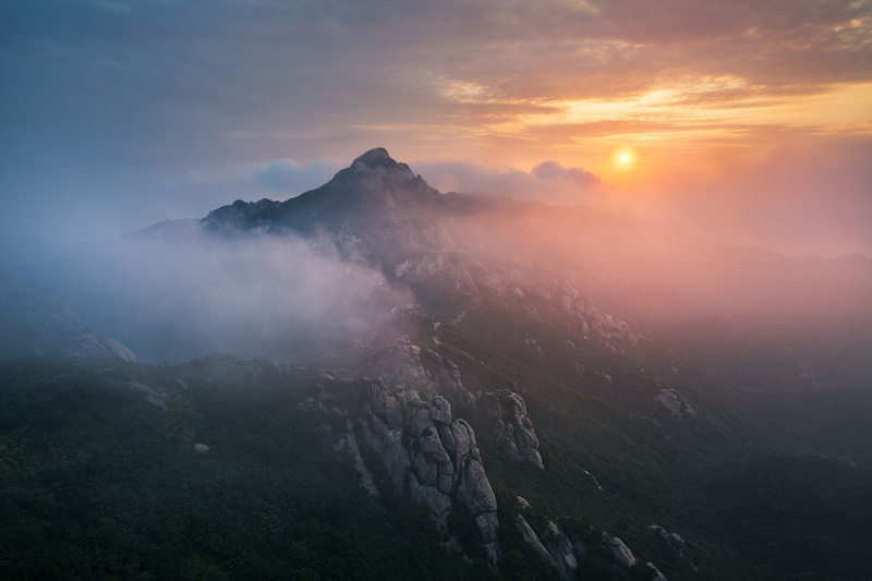 mountain, sunlight, fog, tranquility, landscape, person, nature, mountains, remote, foot, sunset, mountain peak, sky, beauty in nature, tranquil scene