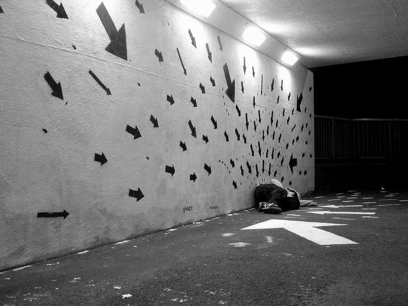 group of animals, architecture, graffiti, indoors, lighting equipment, one person, arrow, leisure activity, monochrome, built structure, wall - building feature