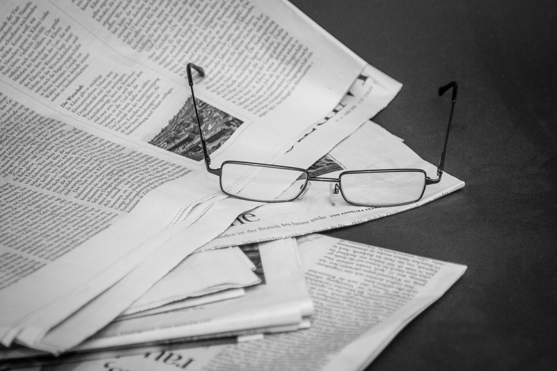 publication, textile, inform, table, personal accessory, open, clothing, glasses, newspaper, newsprint, fashion, close-up, art and craft, indoors, text