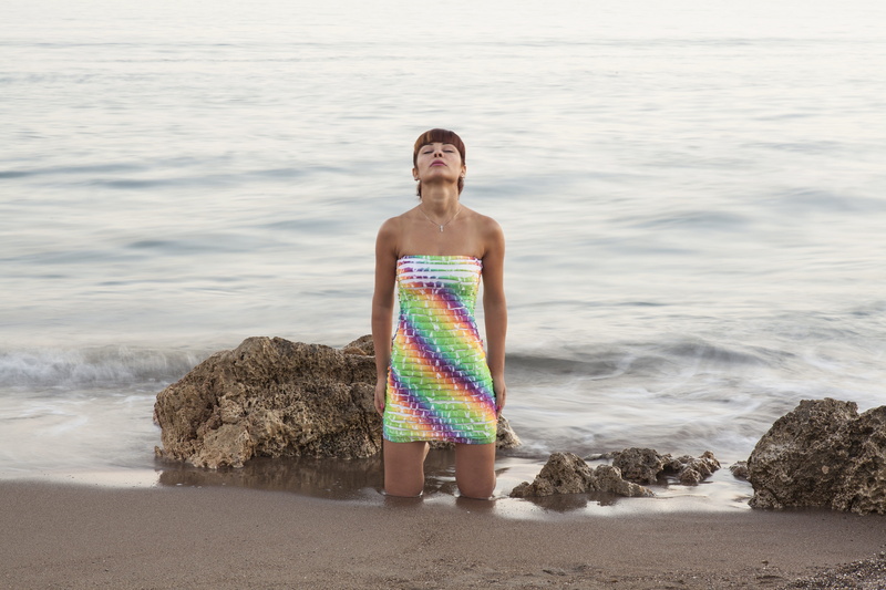 make-up, beach, dress, young, young adult, front view, only, rock, looking at camera, marine, outdoors, peace, design, fine arts, day, sand, water, environmental